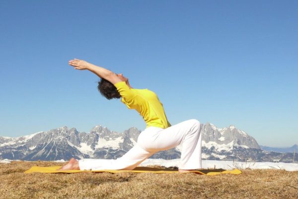 Yoga Half Moon pose in snow